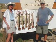 Jim and Teddy Dorland of Anaconda, MT with a day's catch of 8.5, 9.5 and 10 pound walleye and a 5 and 8 pound northern pike.