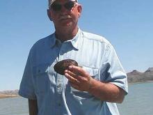 Don Seifert of Queen Creek AZ with a freshwater clam that closed it shells on the treble hook of a crankbait.
