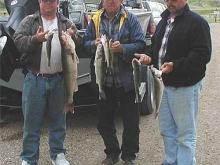 Ed,  Albert and Glen Sutherlin of Stevensville, MT with a day's catch of 5 one-pounders and a 7.5# walleye.