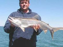 Ross Kellogg, of Ionia, Iowa, with a 12-pound lake trout.