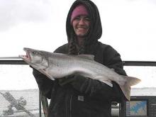 Kara Stewart holds up a 10-pound lake trout.