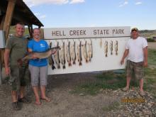 Mark and Laurie Carmichael and Ryan Studer all of Goodland, KS with their first days catch.