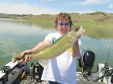 Roxanna Brush of Miles City, MT with a 22 walleye.
