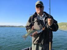 Kip Dean with a smallmputh bass with part of the Fort Peck slam with a fly rod.